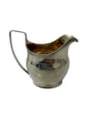 George III silver helmet shaped cream jug with gilded interior, engraved borders and armorial, (Lond