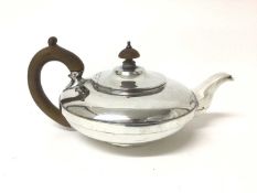 1920s silver teapot of squat melon form, with fruitwood handle and knop (London 1921), all at 19ozs