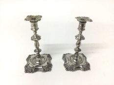 Pair of Georgian-style silver taper sticks of typical form on foliate shell bases (Sheffield 1900),