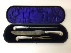 Good quality late Victorian silver handled carving set with pistol grips decorated with scrollwork (