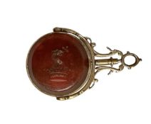 Good quality late Victorian gold (unmarked) fob with revolving hardstone panels, one side with carve