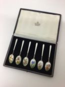 Cased set of six sterling silver and enamelled tea spoons, each decorated with different flowers on