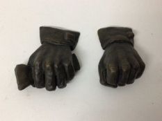 Stephen Lansley, two bronze studies of human fists, one holding a newspaper, both signed with initia