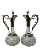 Pair elegant late 19th century Continental white metal mounted and cut glass claret jugs of classica