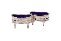 Pair of silver oval pierced salt cellars, blue glass liners