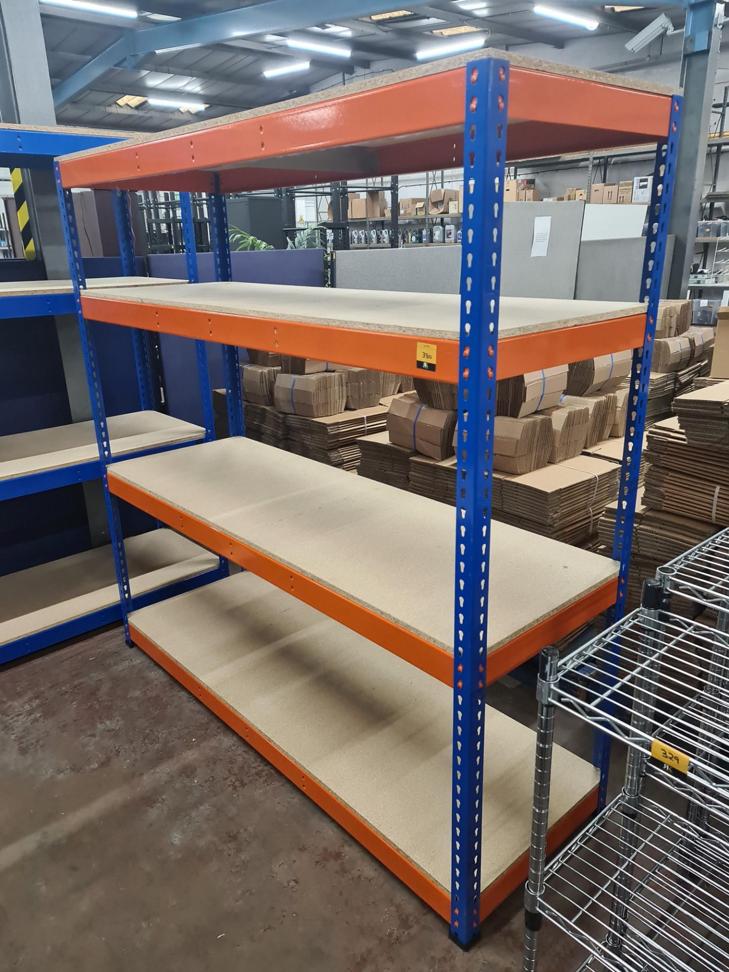 Blue and orange shelving unit including four shelves. Orange beam marked UA72. Footprint of bay ap