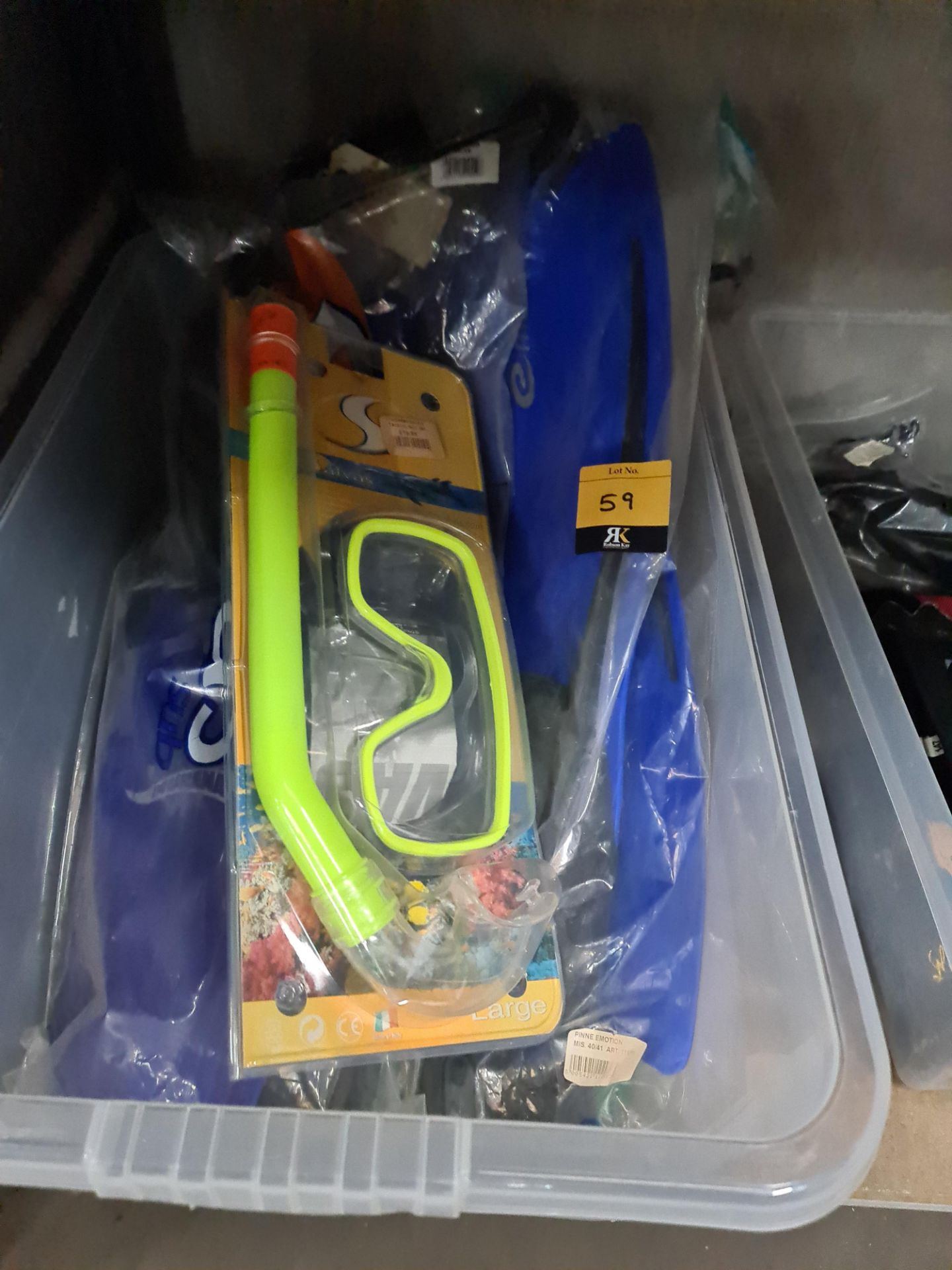 The contents of a crate of water sports related items comprising flippers, goggles, snorkel and simi