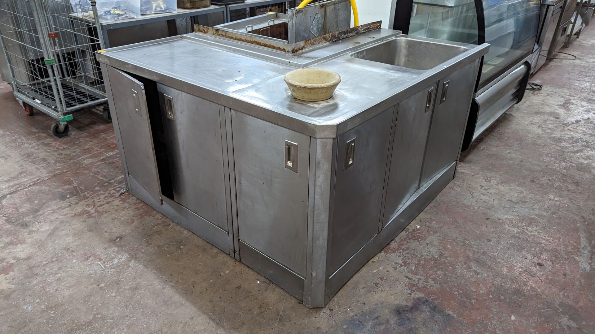 Large stainless steel corner unit incorporating basin, storage & more