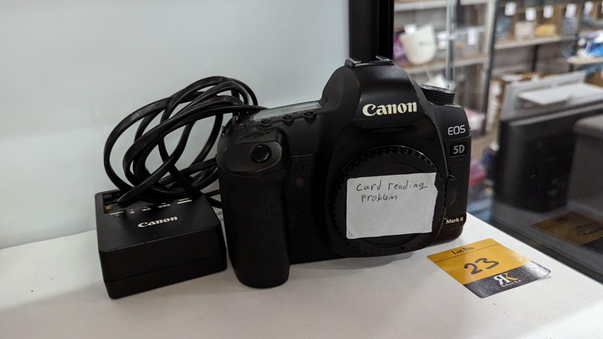 Canon EOS 5D Mark II digital camera plus Canon battery charger. N.B. no lens or battery included wi