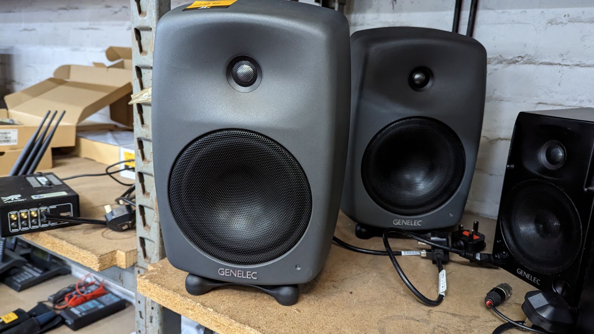 Pair of Genelec model 8040B bi-amplified monitors/speakers. Each speaker includes a desktop stand
