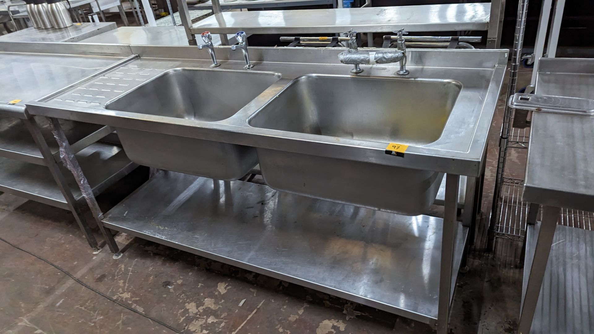Stainless steel floor standing twin bowl sink arrangement with drainer to the left