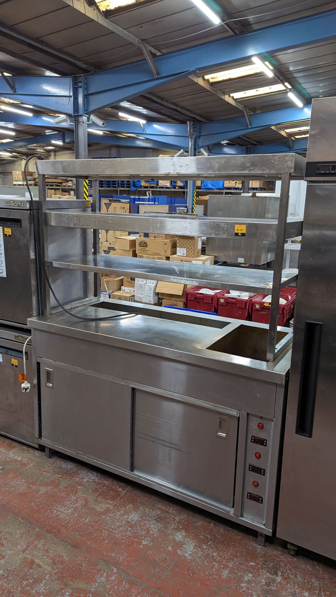 Large stainless steel warming unit with multi-tier shelving above