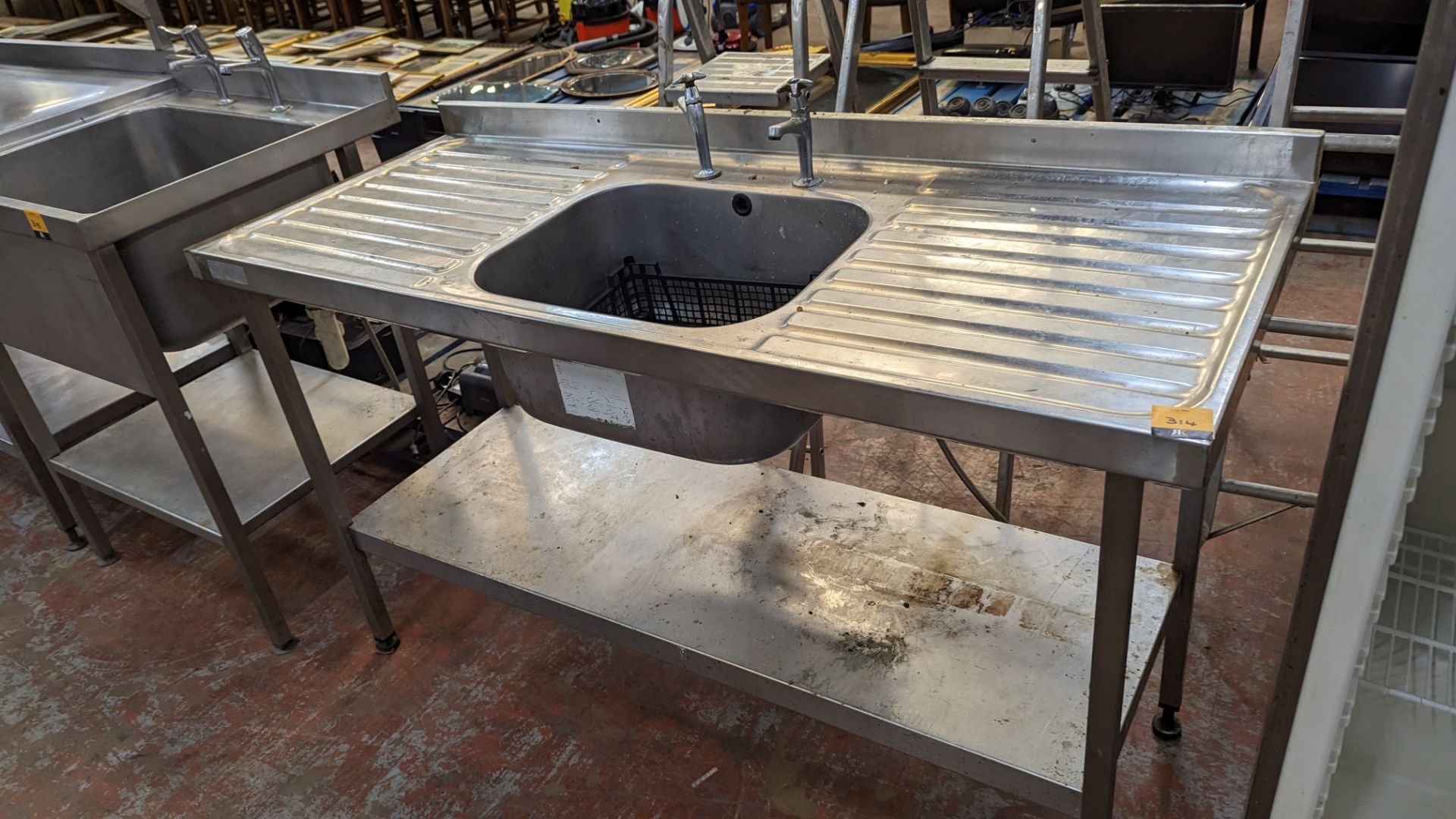 Stainless steel free standing basin arrangement with drainers to either side and shelf below