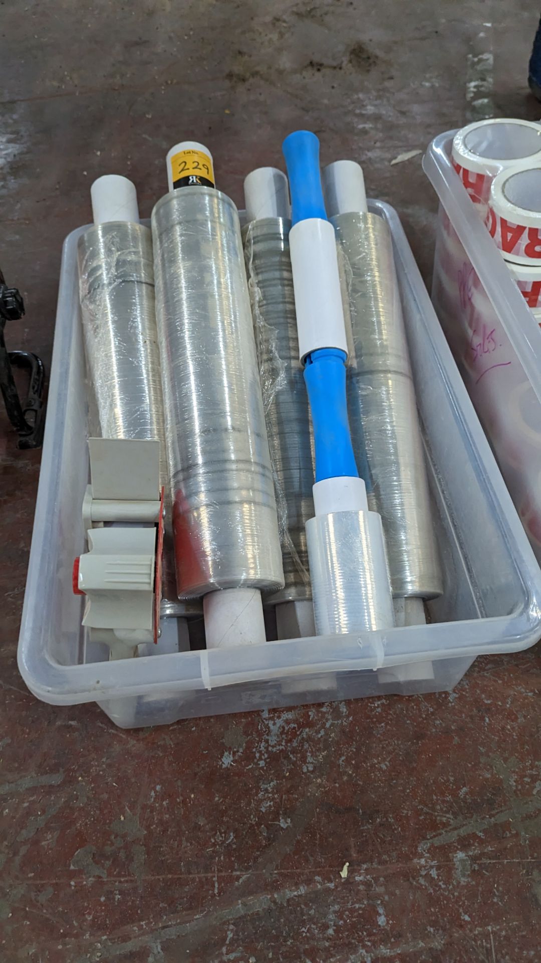 The contents of a crate of shrink wrap plus shrink wrap handle & tape gun