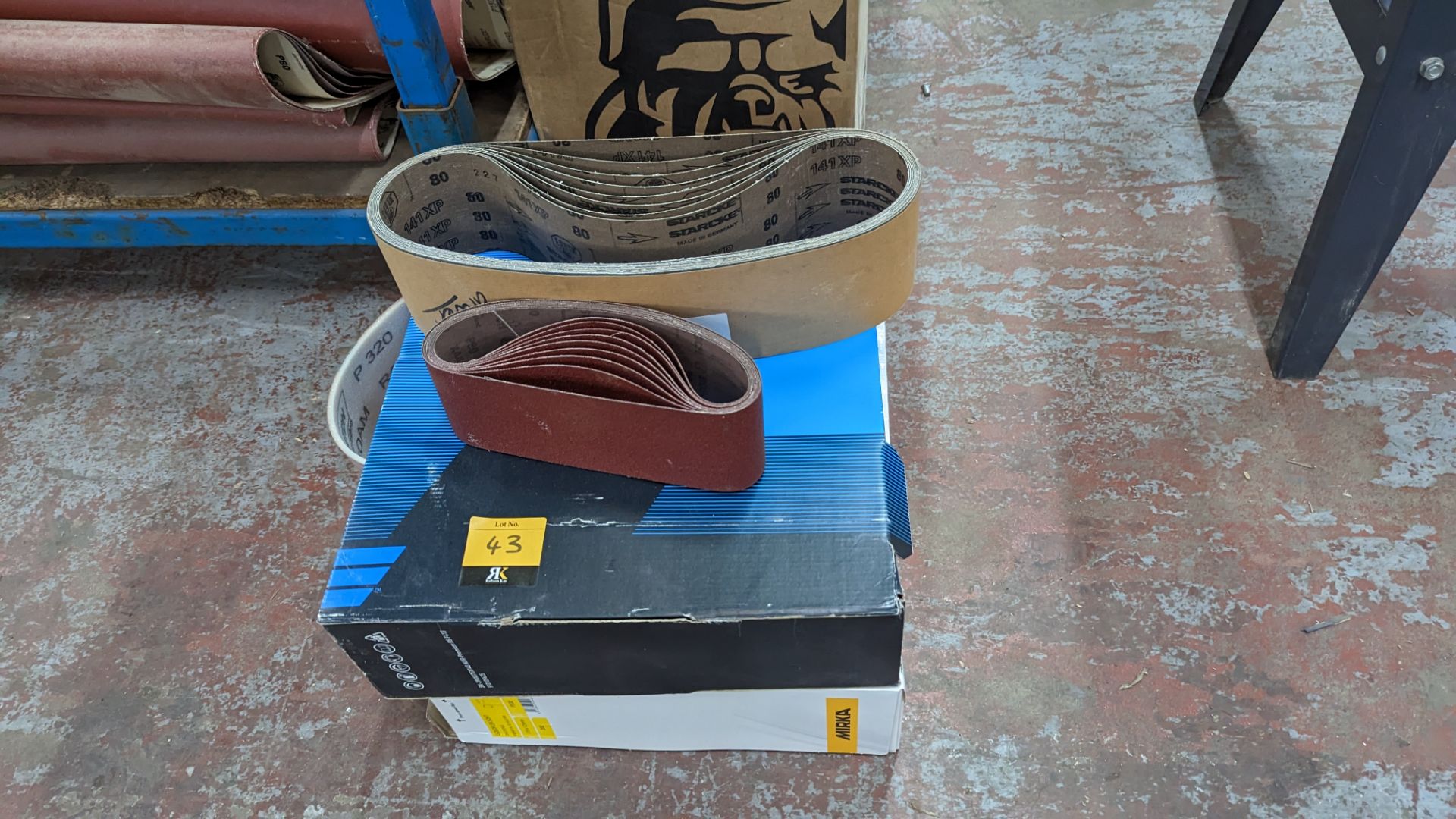 Stack of assorted sanding belts & related items