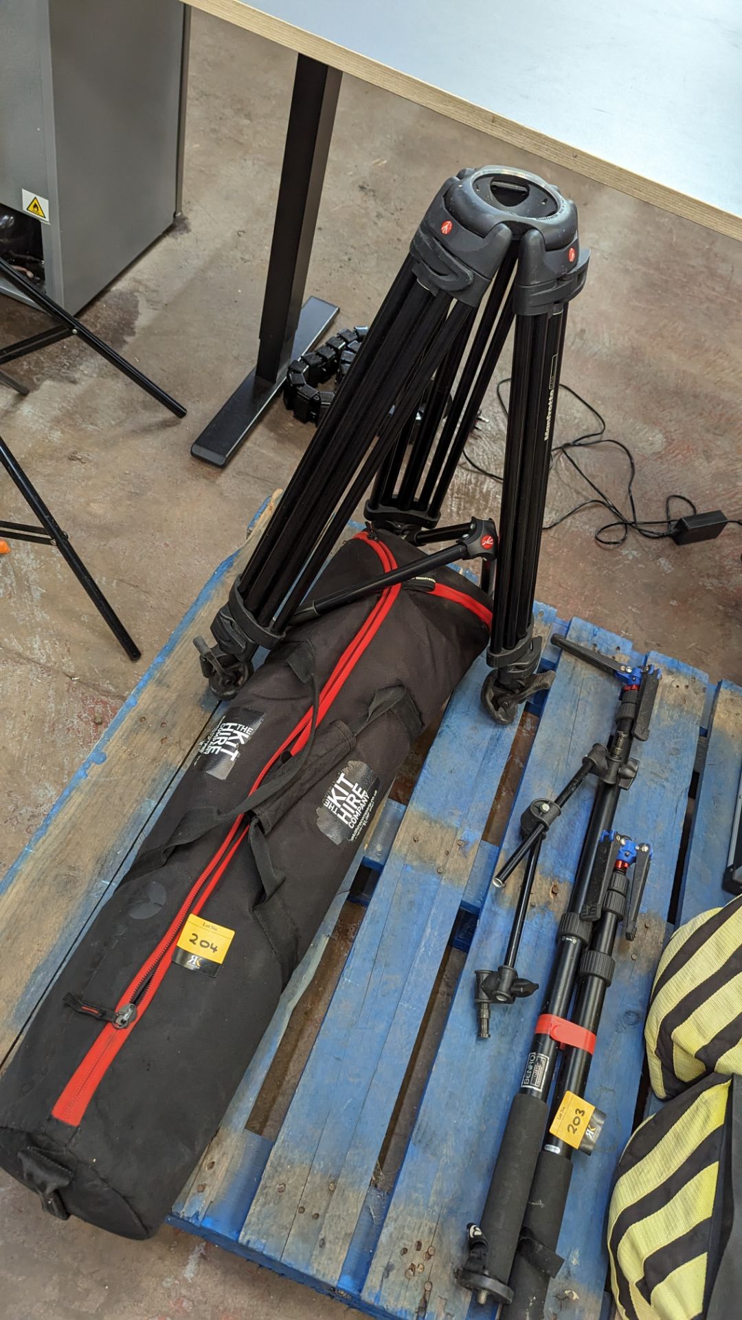 Mixed lot comprising Manfrotto 545B tripod legs (no head), mid level spreader & soft bag (damage to
