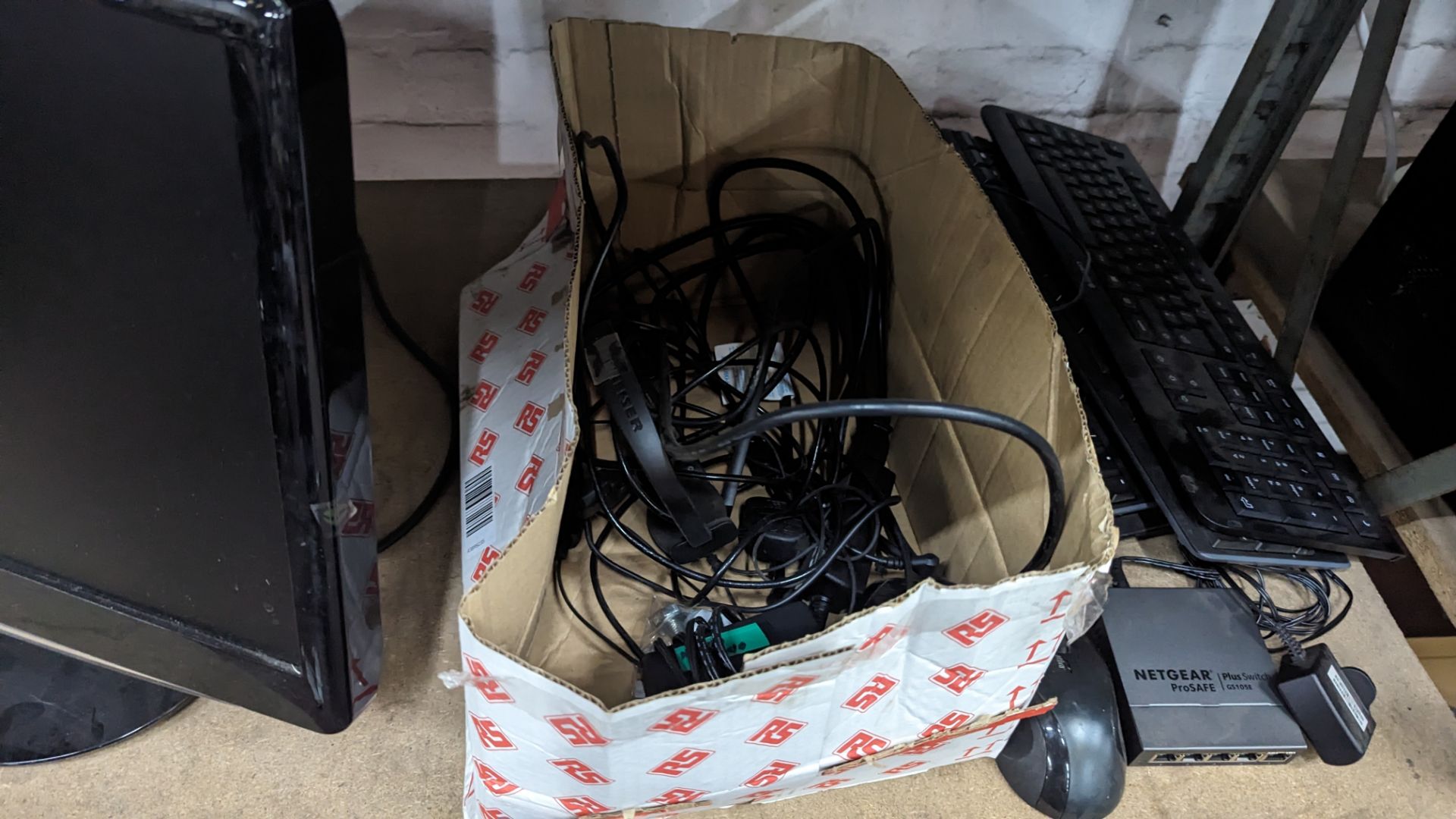 The contents of a shelf of assorted IT equipment including monitors, cables, keyboards, headphones & - Image 7 of 10