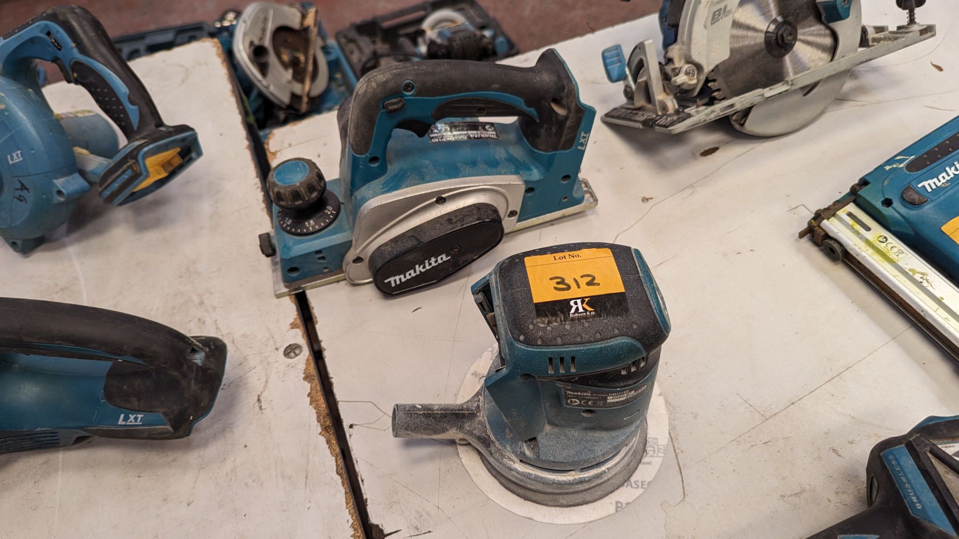 Pair of assorted Makita cordless woodworking related power tools comprising model DBO180 sander & mo