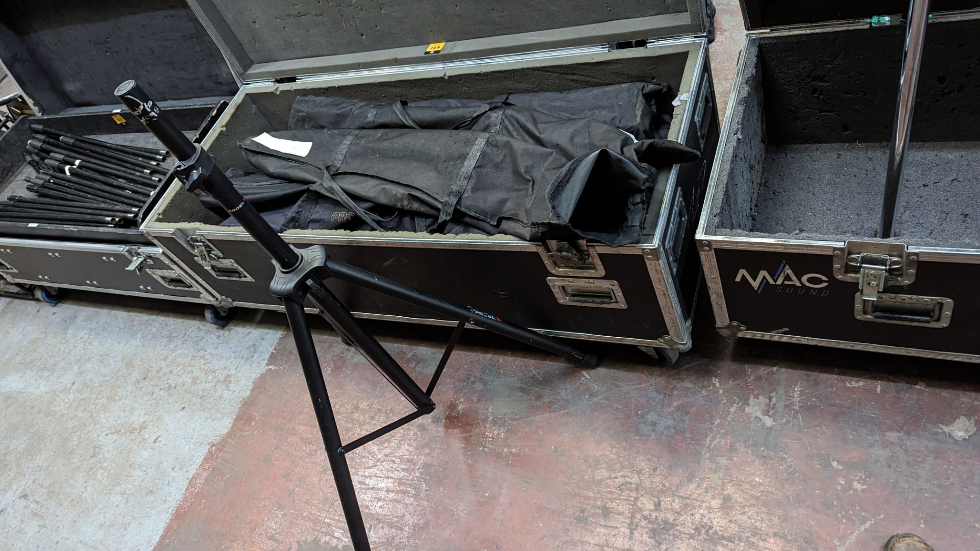 7 off Proel speaker stands each in their own bag. This lot includes large mobile flight case. Tota