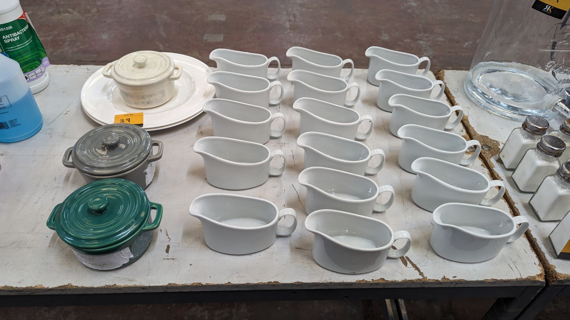A mixed crockery lot comprising 17 gravy boats plus 3 small pots with lids and 2 dinnerplates