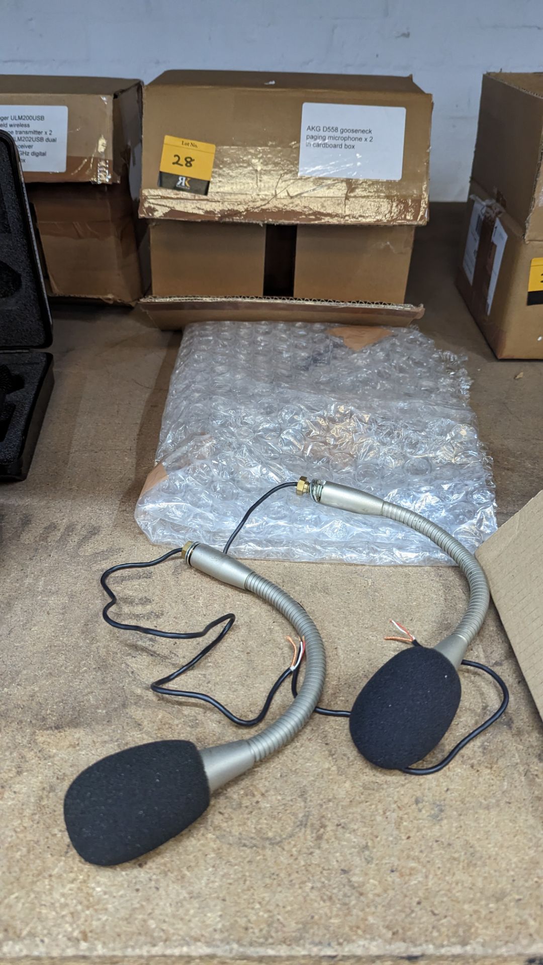 2 off AKG model D558 gooseneck paging microphones. This lot includes a cardboard box