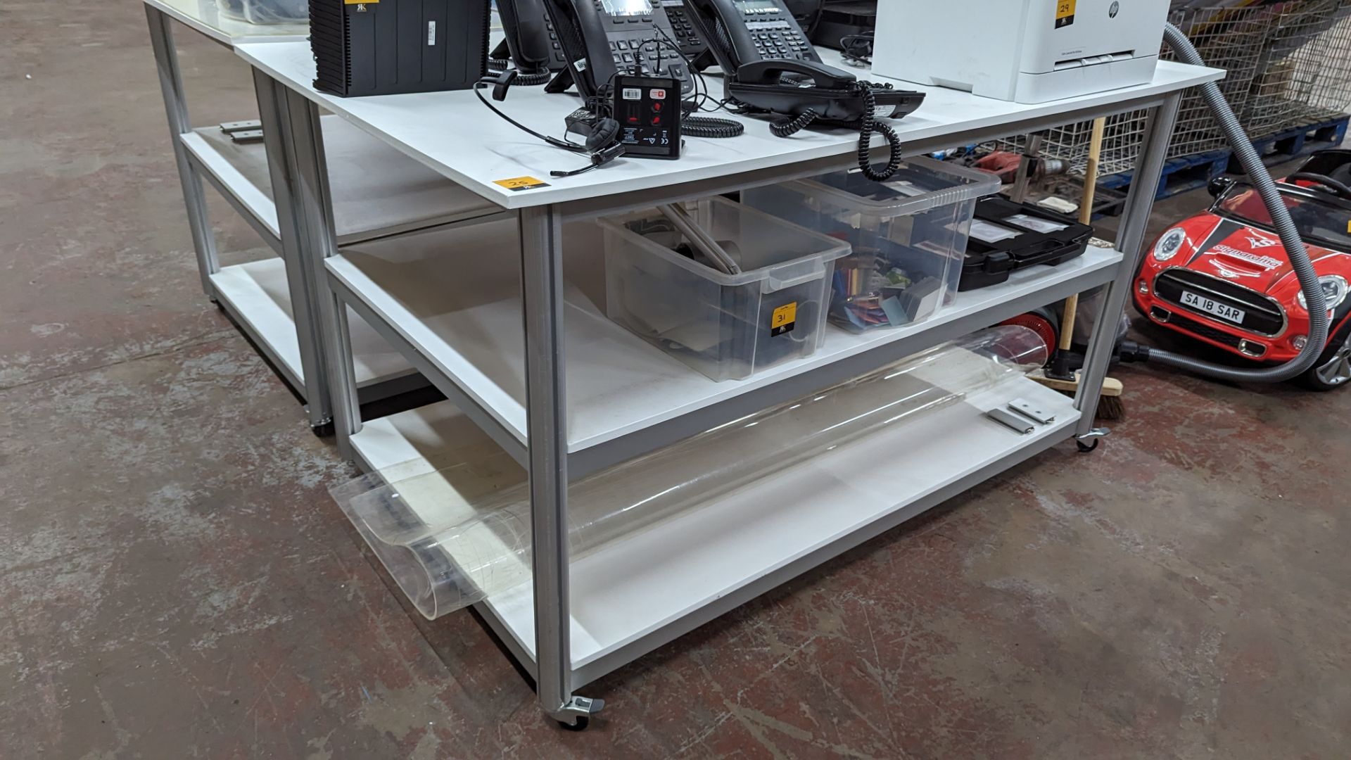 Mobile worktable with 2 shelves underneath the main work surface. Includes protective sheet in very