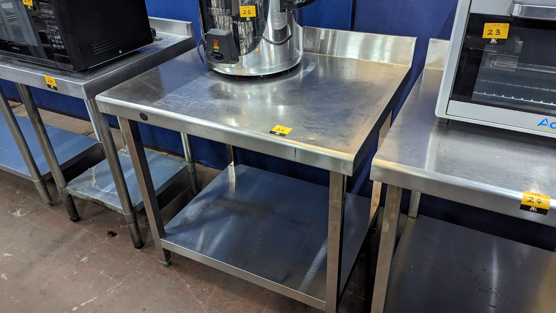 Stainless steel twin tier table with upstand to the rear. Dimensions 900mm x 700mm x 950mm