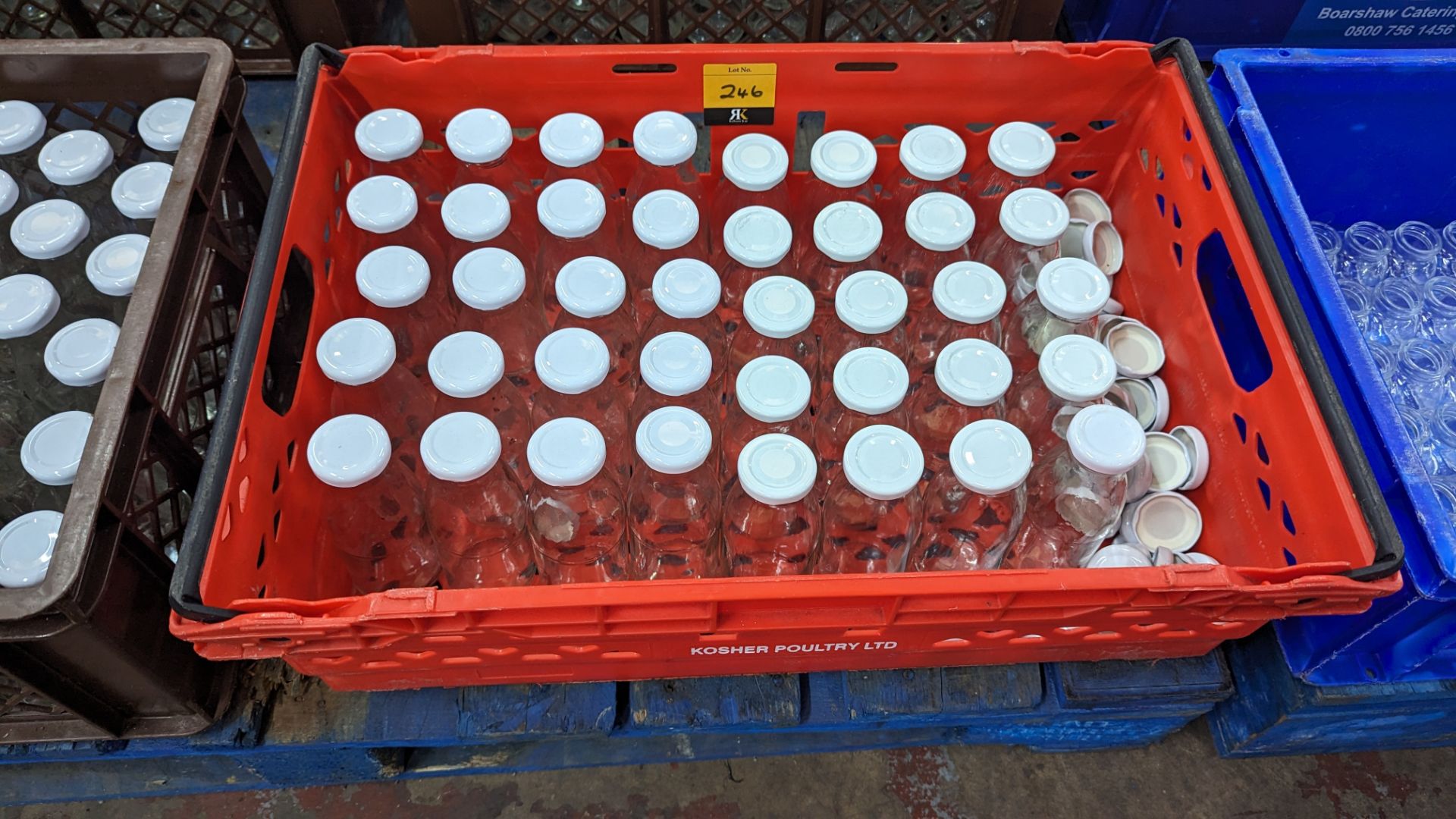 The contents of a crate of glass bottles with screw on lids