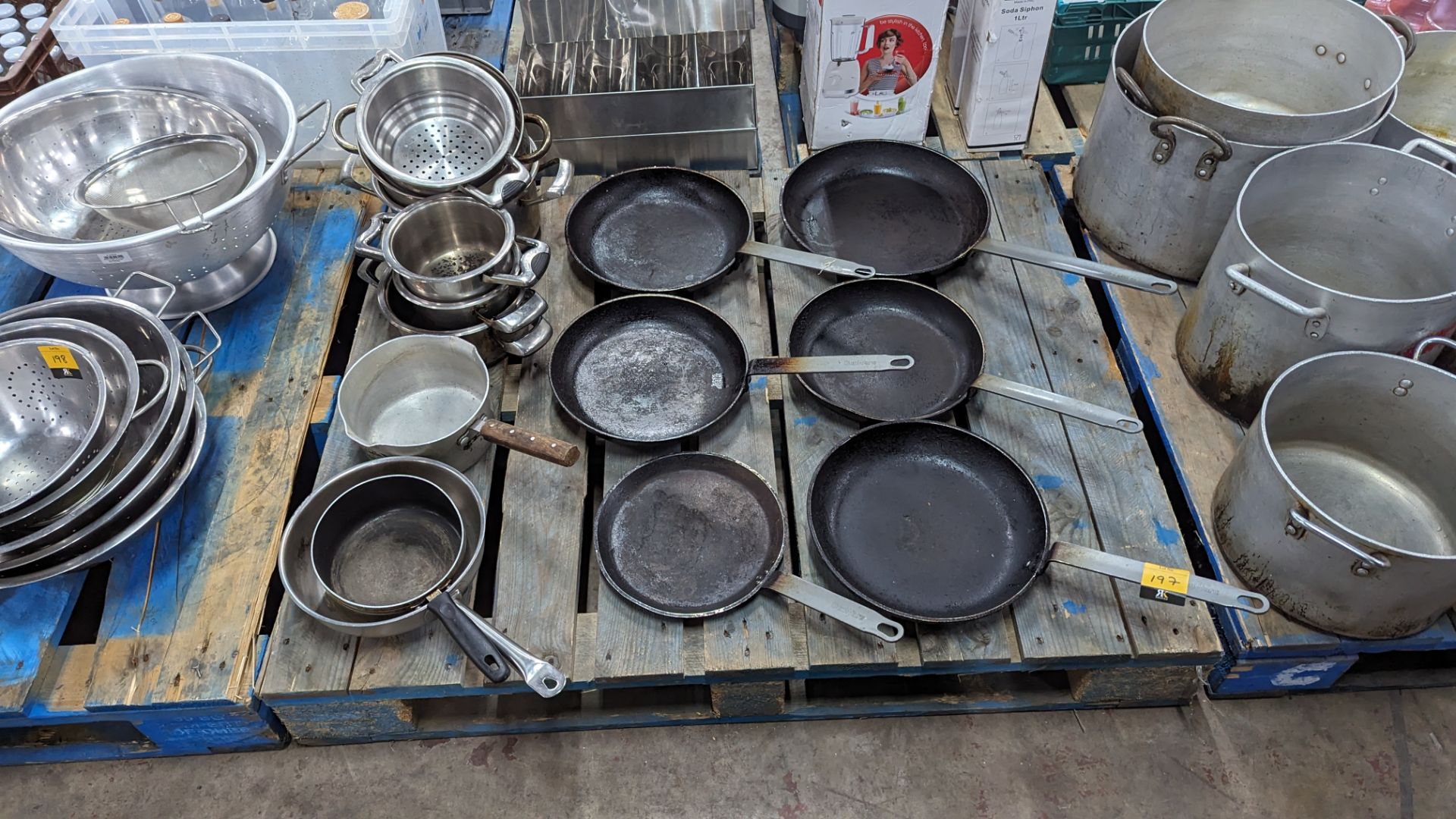 The contents of a pallet of assorted pans - 6 skillets plus 9 assorted saucepans & similar