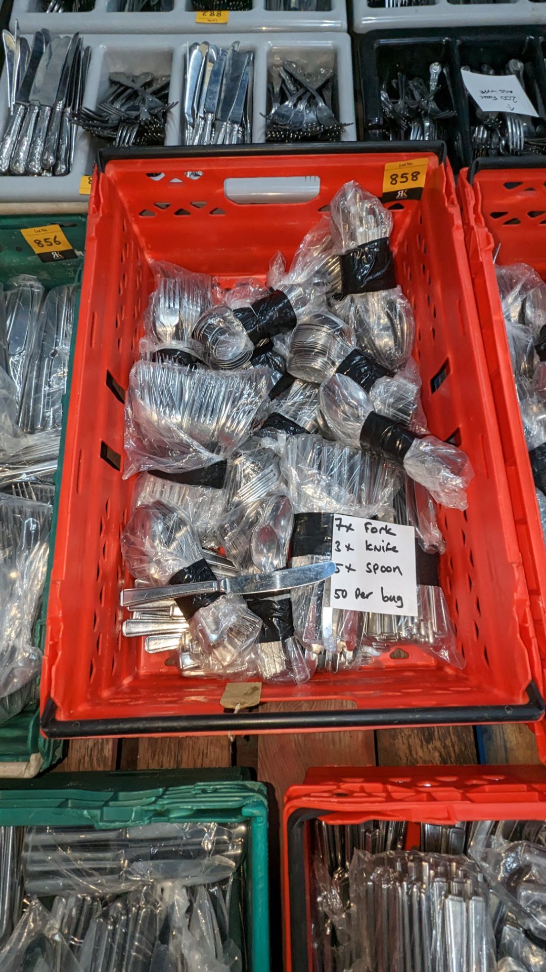 The contents of a crate of cutlery. Approximately 800 pieces in total, comprising 7 bags of forks,