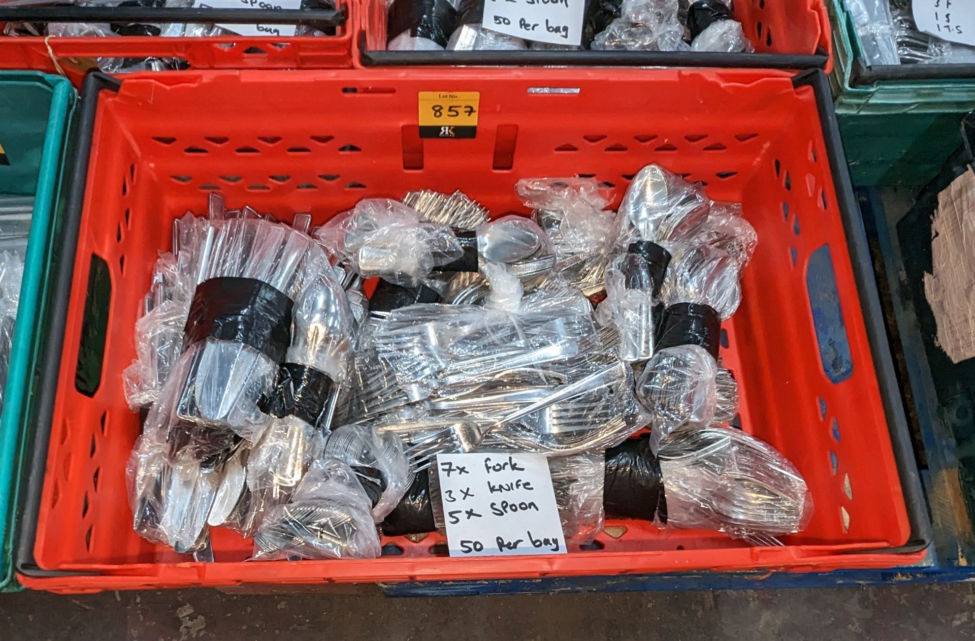 The contents of a crate of cutlery. Approximately 800 pieces in total, comprising 7 bags of forks,