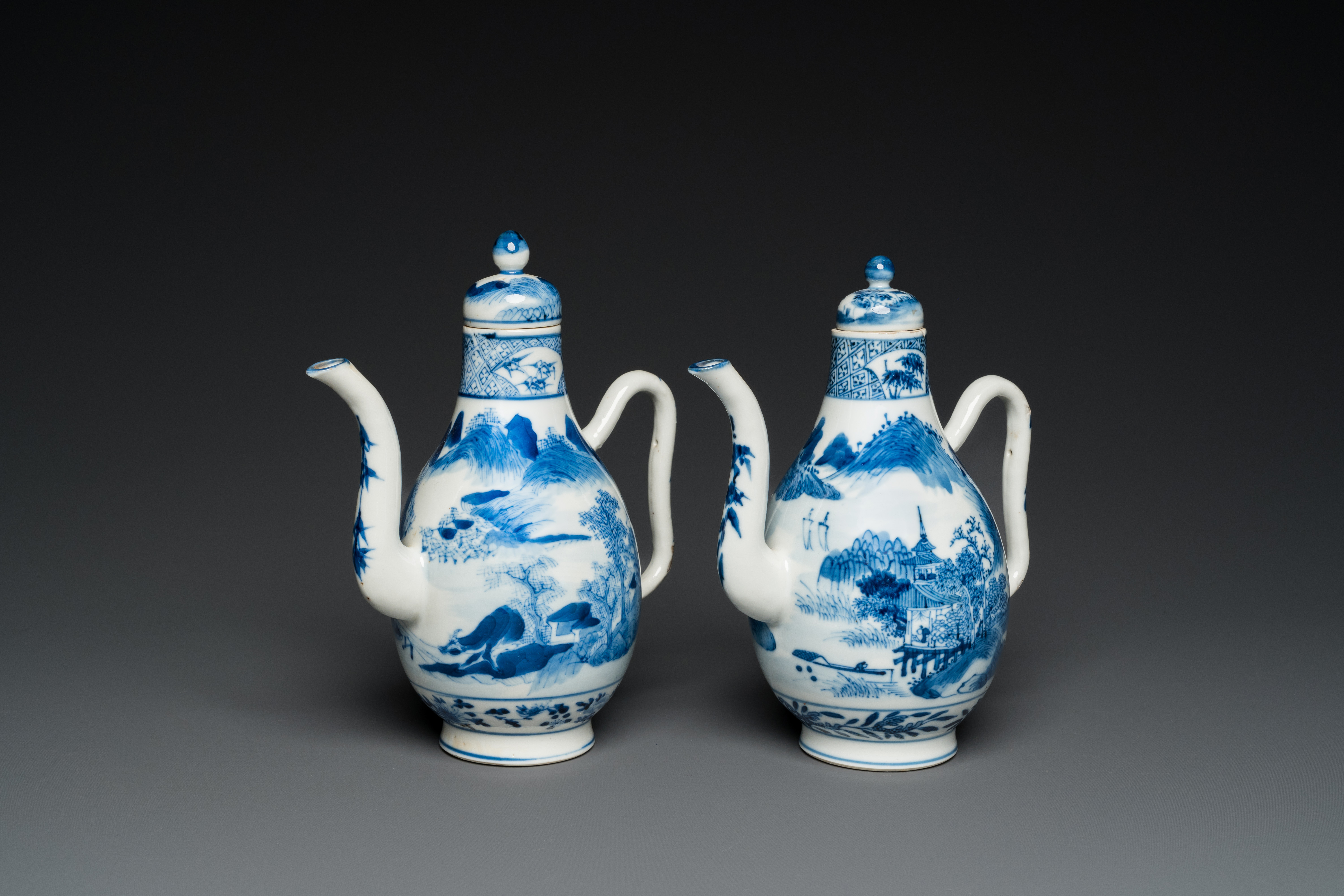 A pair of Chinese blue and white 'landscape' ewers and covers, possibly for the Vietnamese market, 1