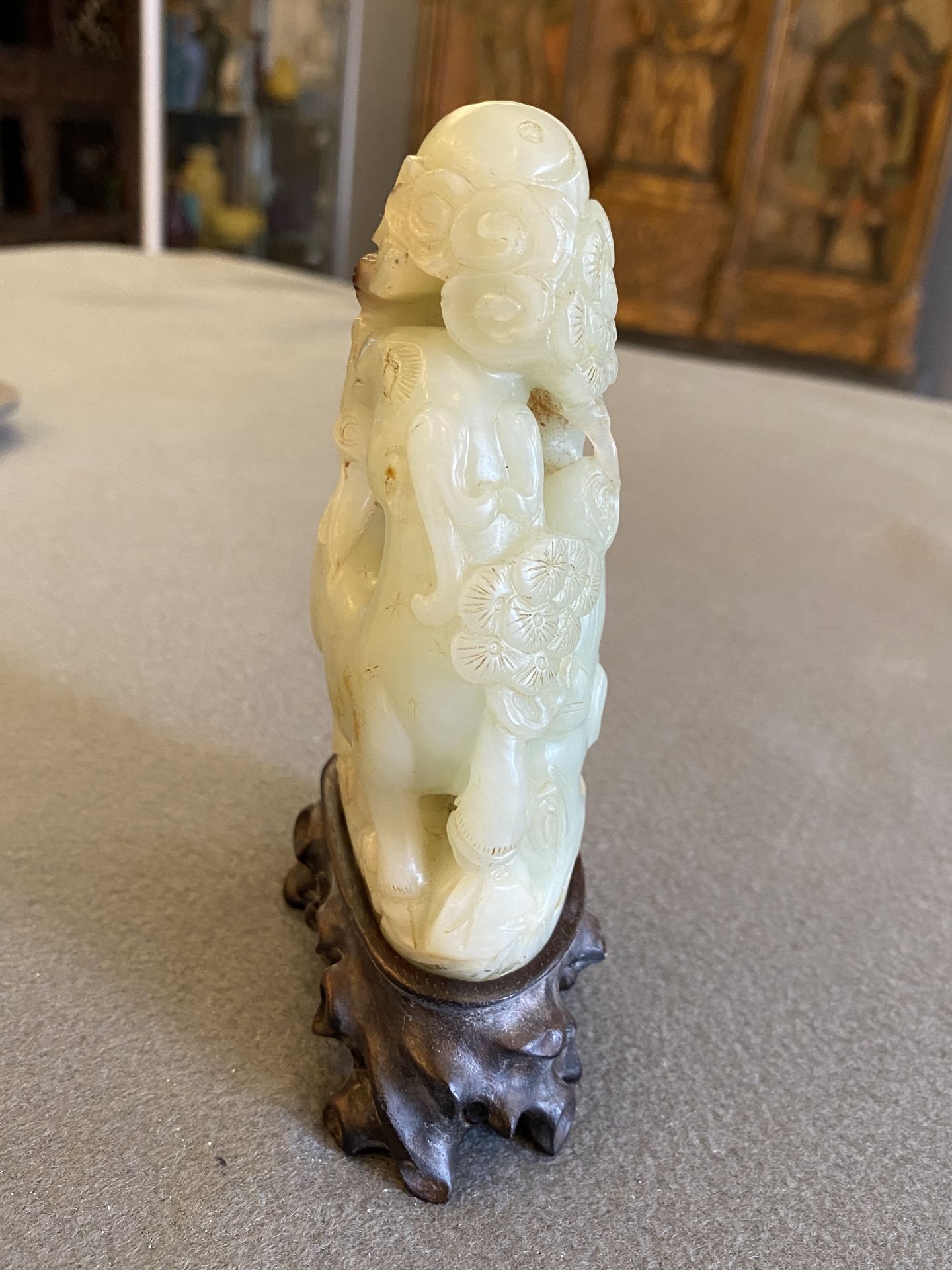 A Chinese celadon and russet jade ram sculpture on wooden stand, 19th C. - Image 9 of 18