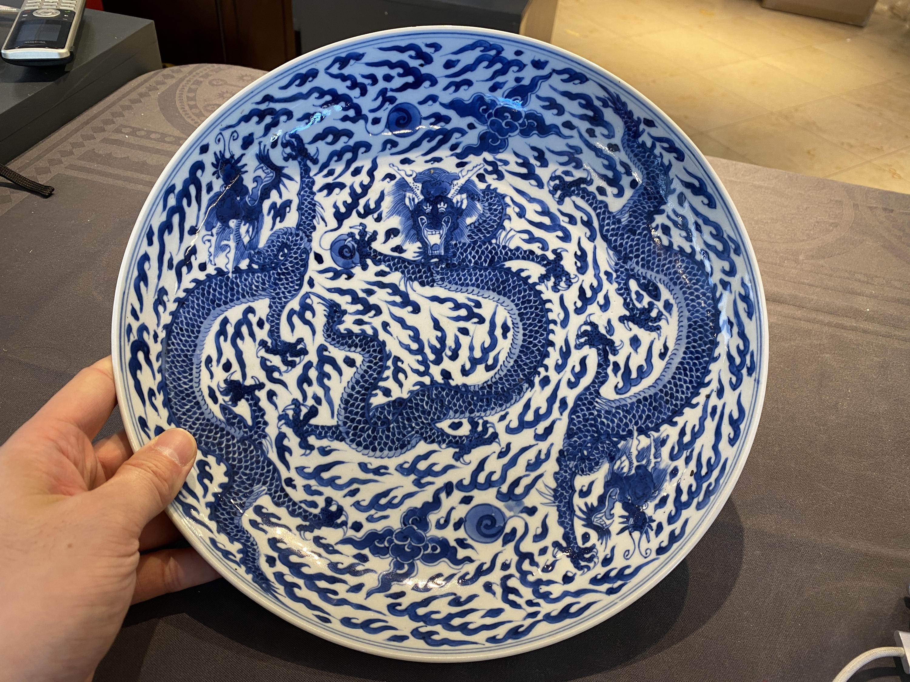 A Chinese blue and white 'dragon' dish, Kangxi mark and of the period - Image 3 of 18