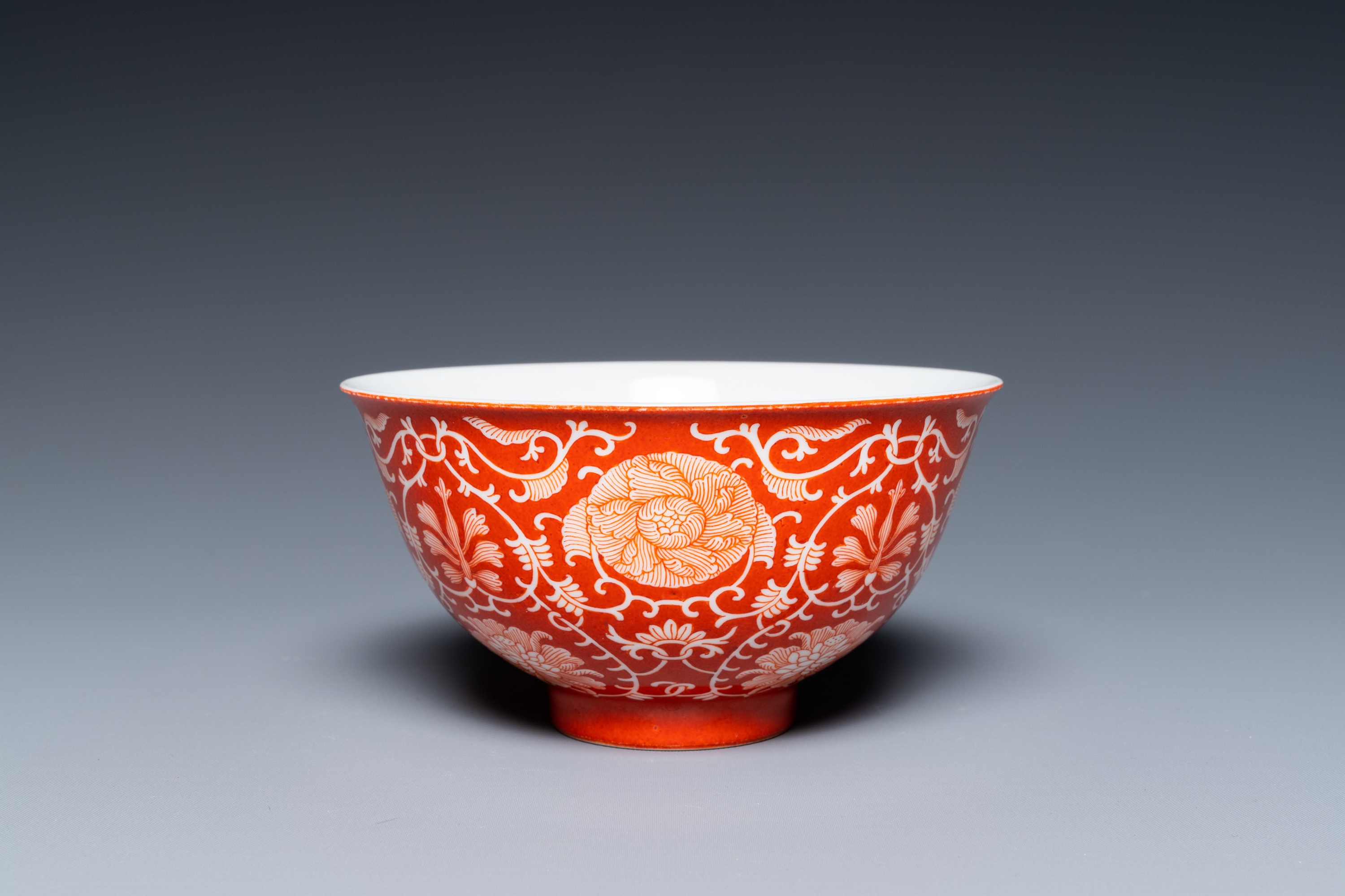 A Chinese coral-ground reserve-decorated 'lotus' bowl, Jiaqing mark, 19/20th C.