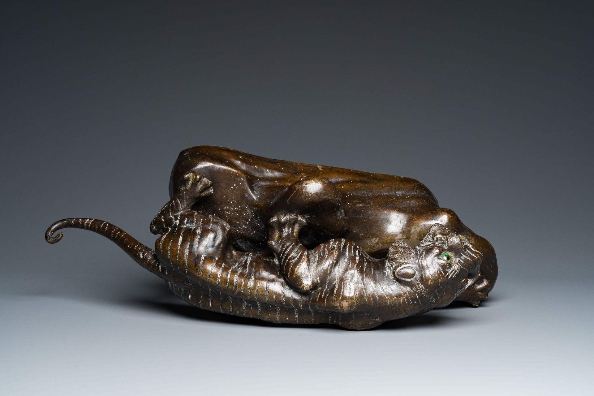 A large Vietnamese bronze tiger on a carved wooden stand, 19/20th C. - Image 7 of 10