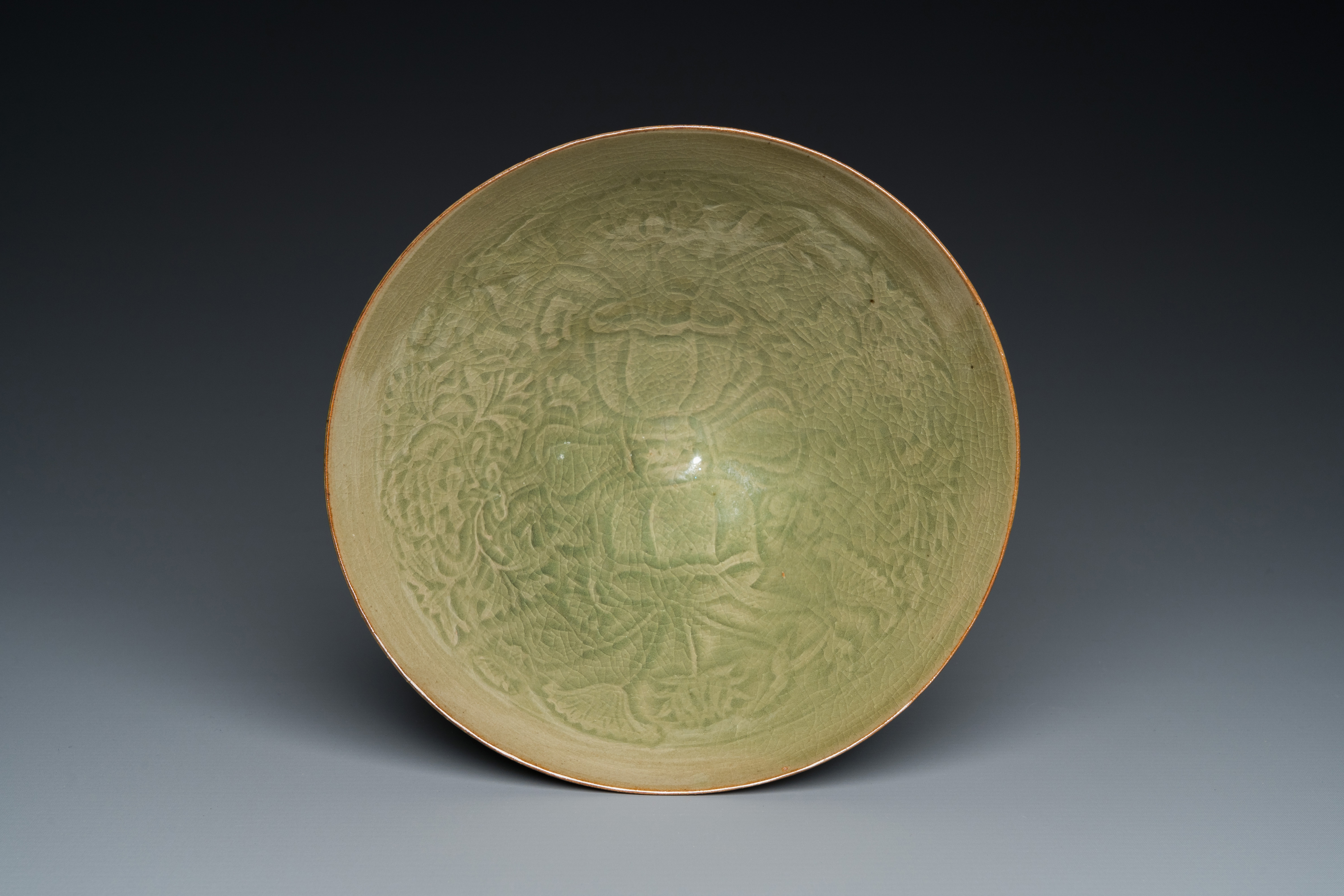 A Chinese Yaozhou celadon bowl with underglaze floral design, probably Song