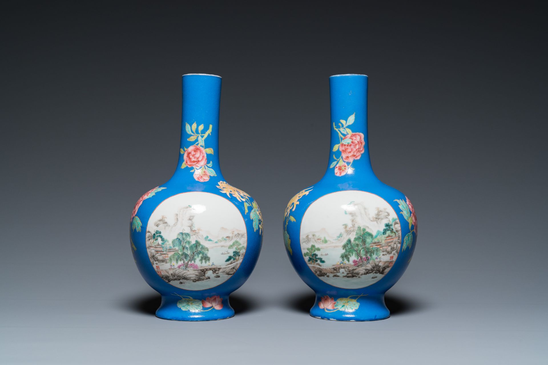 A pair of Chinese blue-ground famille rose vases, He Xuren ___ seal mark, 20th C.