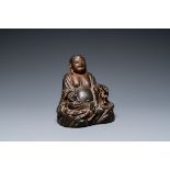 A Chinese gilt bronze figure of Buddha seated on a rock, Ming