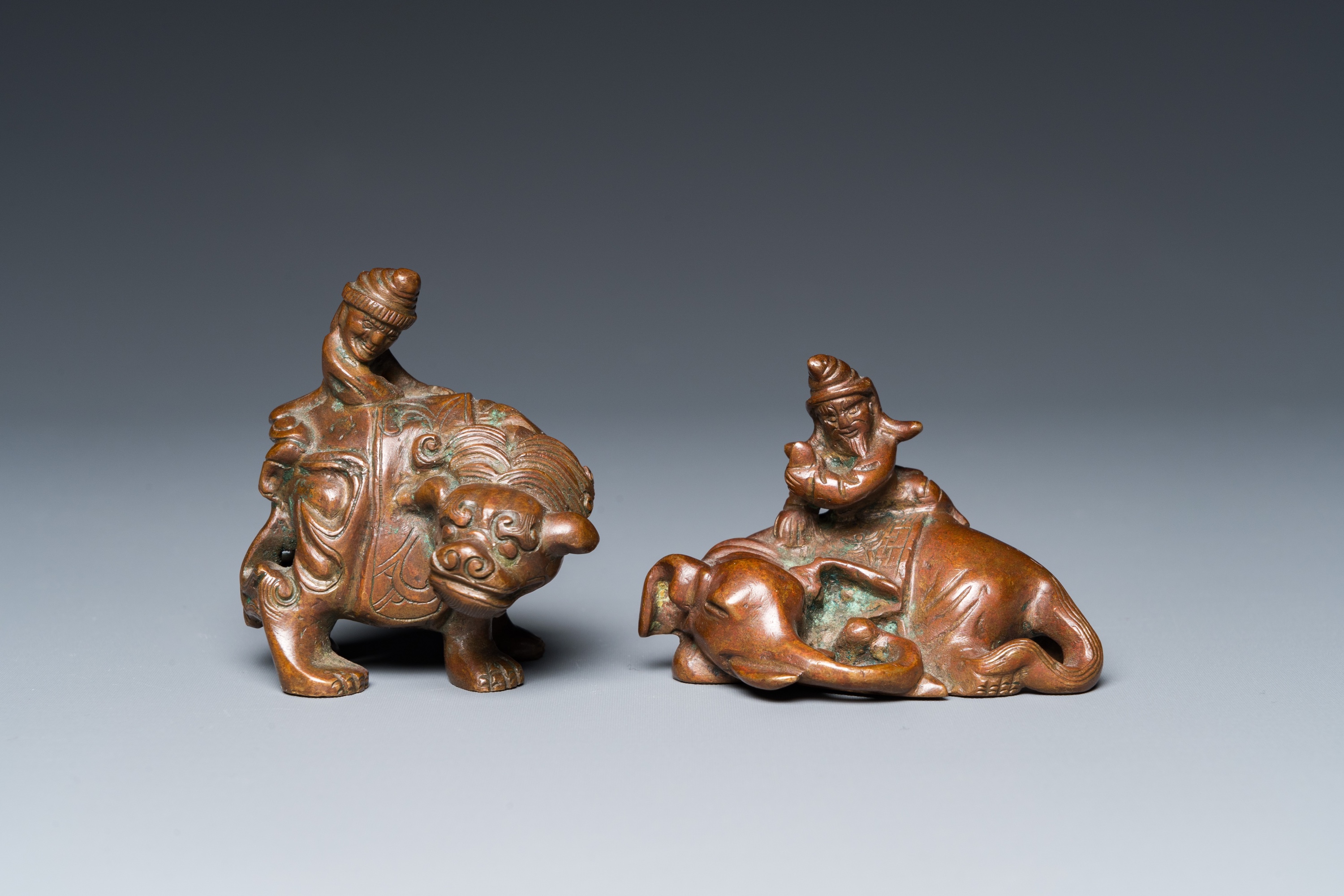 Two Chinese bronze scroll Weights with Sogdian riders on a Buddhist lion and an elephant, Qi