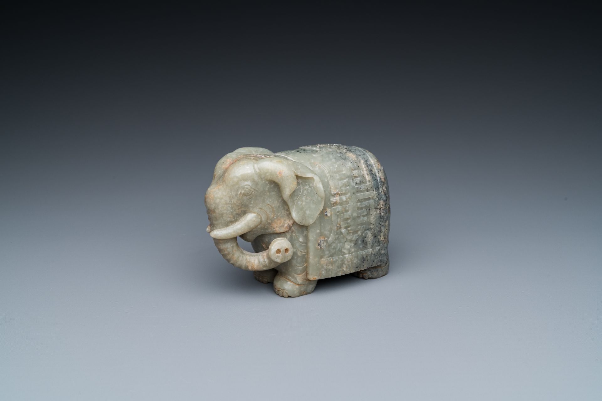 A Chinese grey-speckled celadon jade elephant, Qing