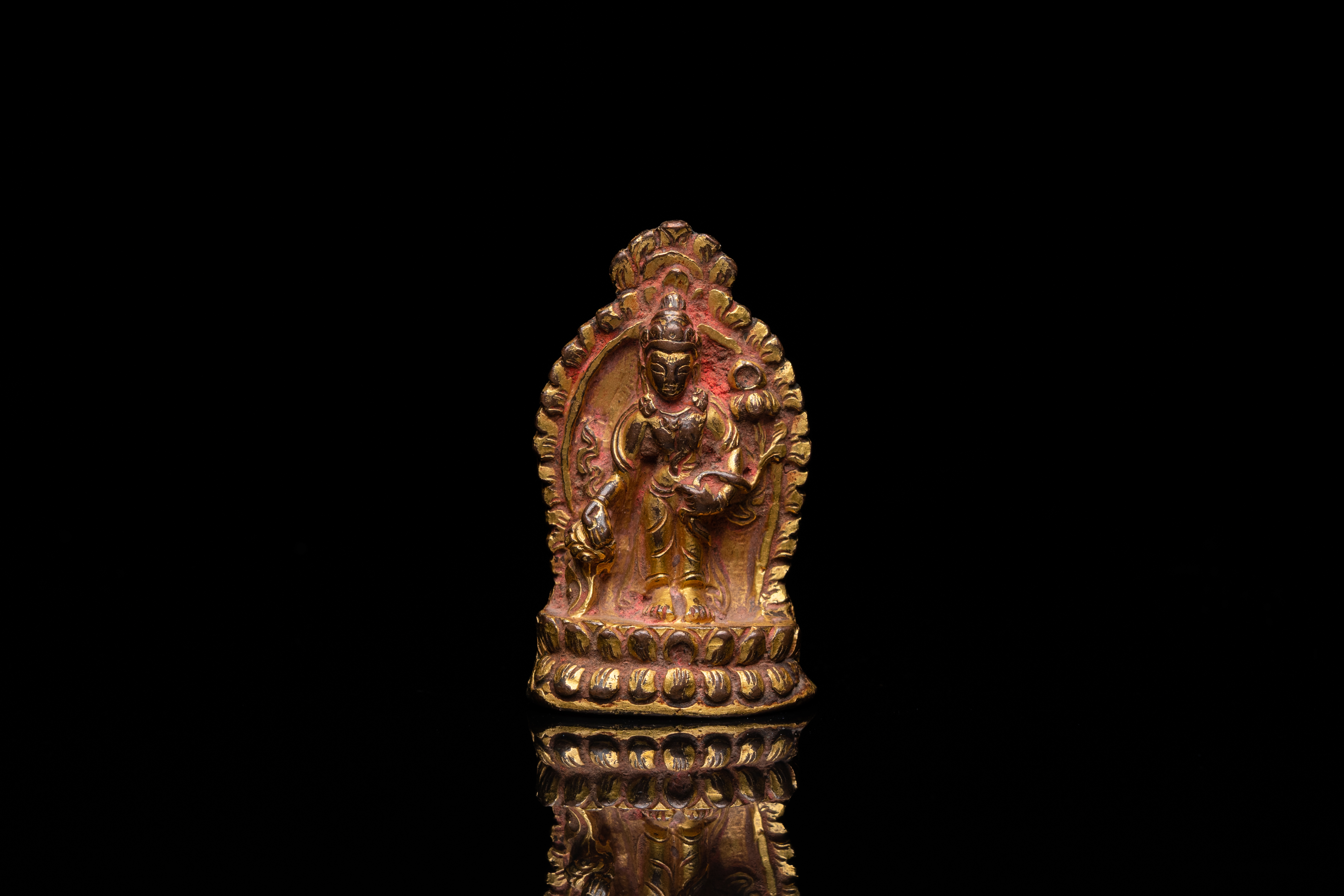 A lacquered gilt bronze miniature Buddha, Tibet or Nepal, 15/16th C.