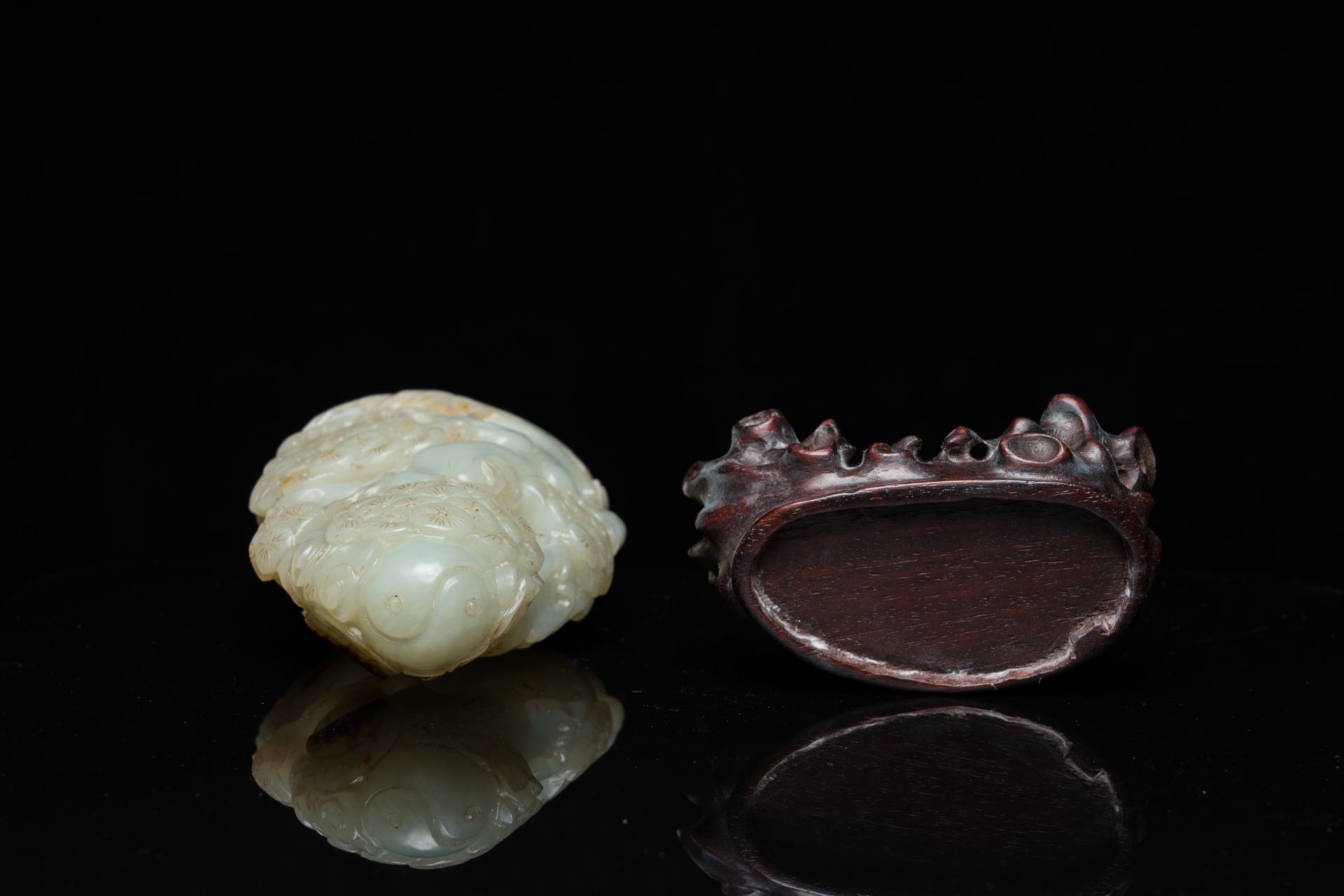 A Chinese celadon and russet jade ram sculpture on wooden stand, 19th C. - Image 6 of 18