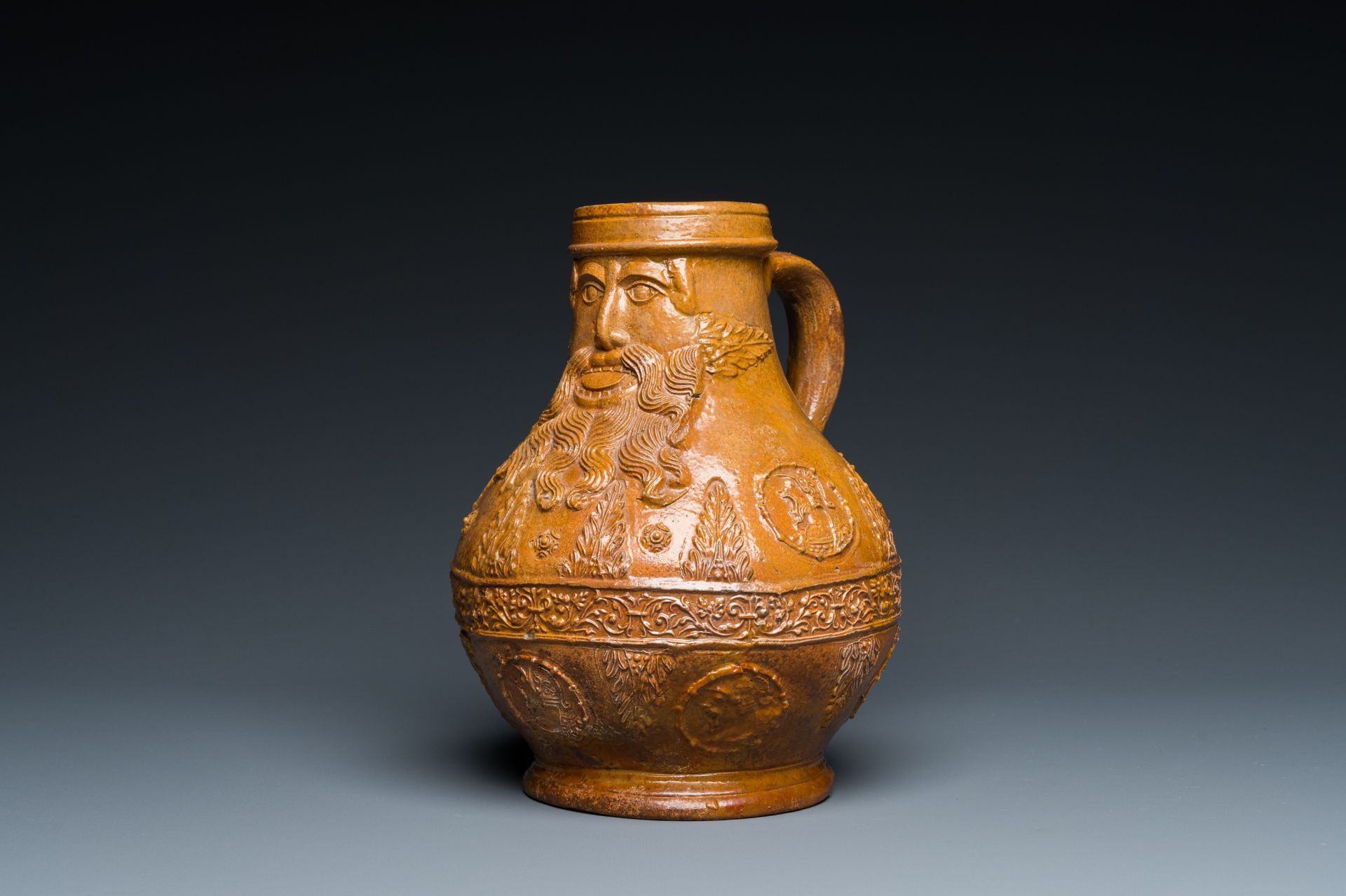 A rare German stoneware bellarmine jug with a bearded face sticking his tongue out, Cologne, 16th C. - Image 7 of 10