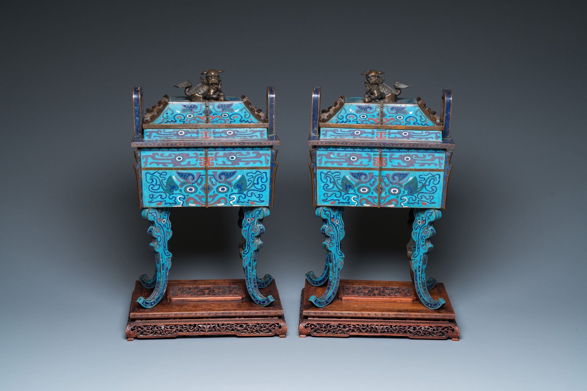 A pair of large Chinese cloisonnŽ 'fangding' censers and covers on wooden stands, 19th C.