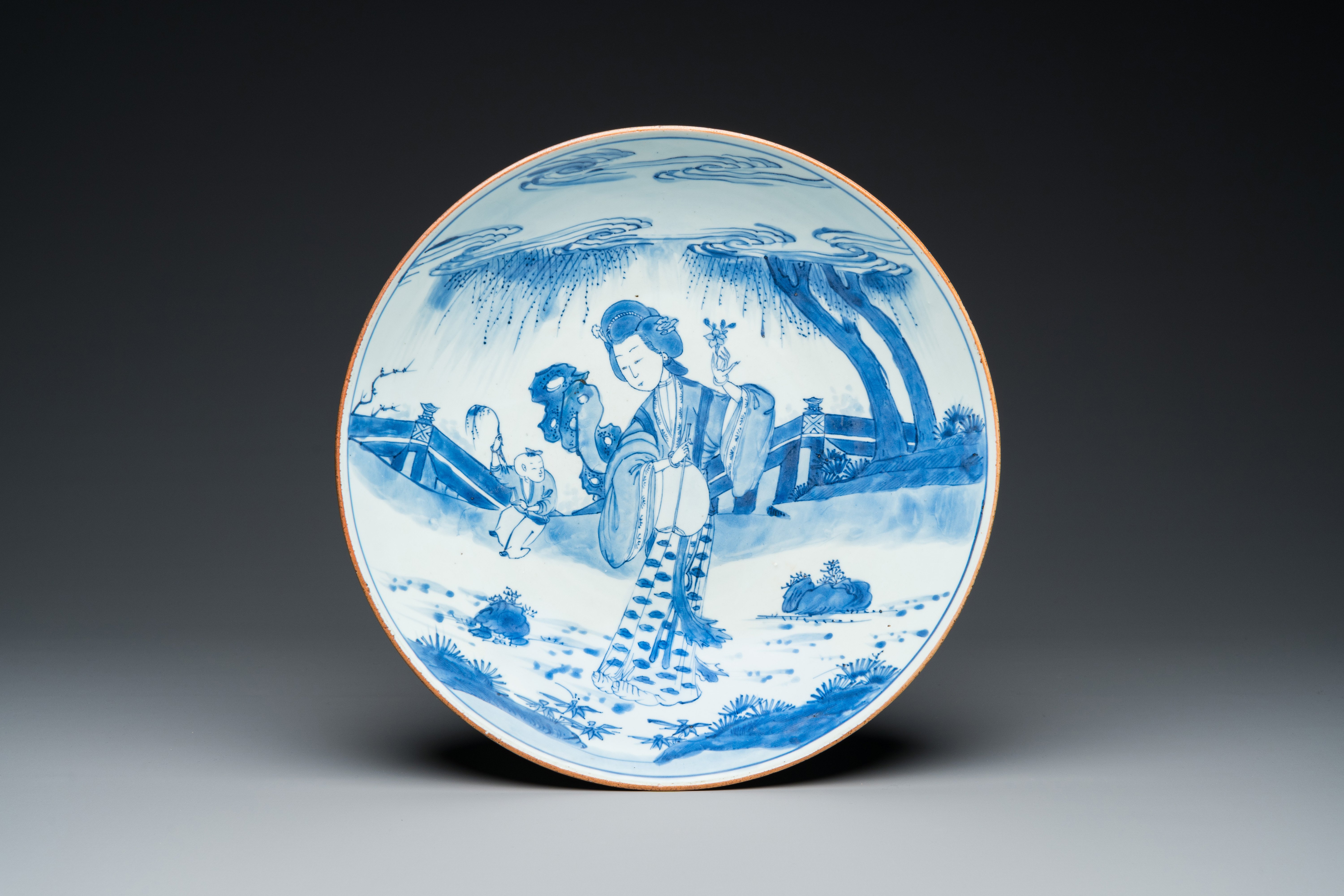 A large Chinese blue and white 'lady and boy' dish, Kangxi mark and of the period