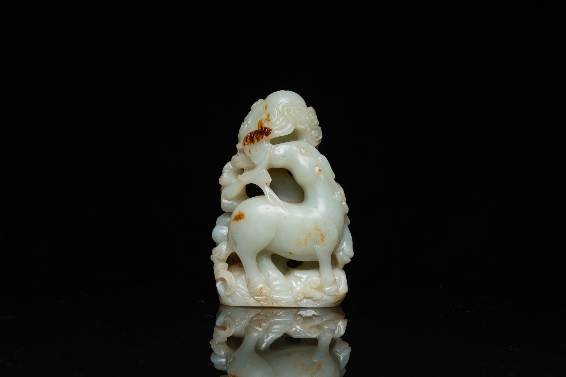 A Chinese celadon and russet jade ram sculpture on wooden stand, 19th C. - Image 2 of 18