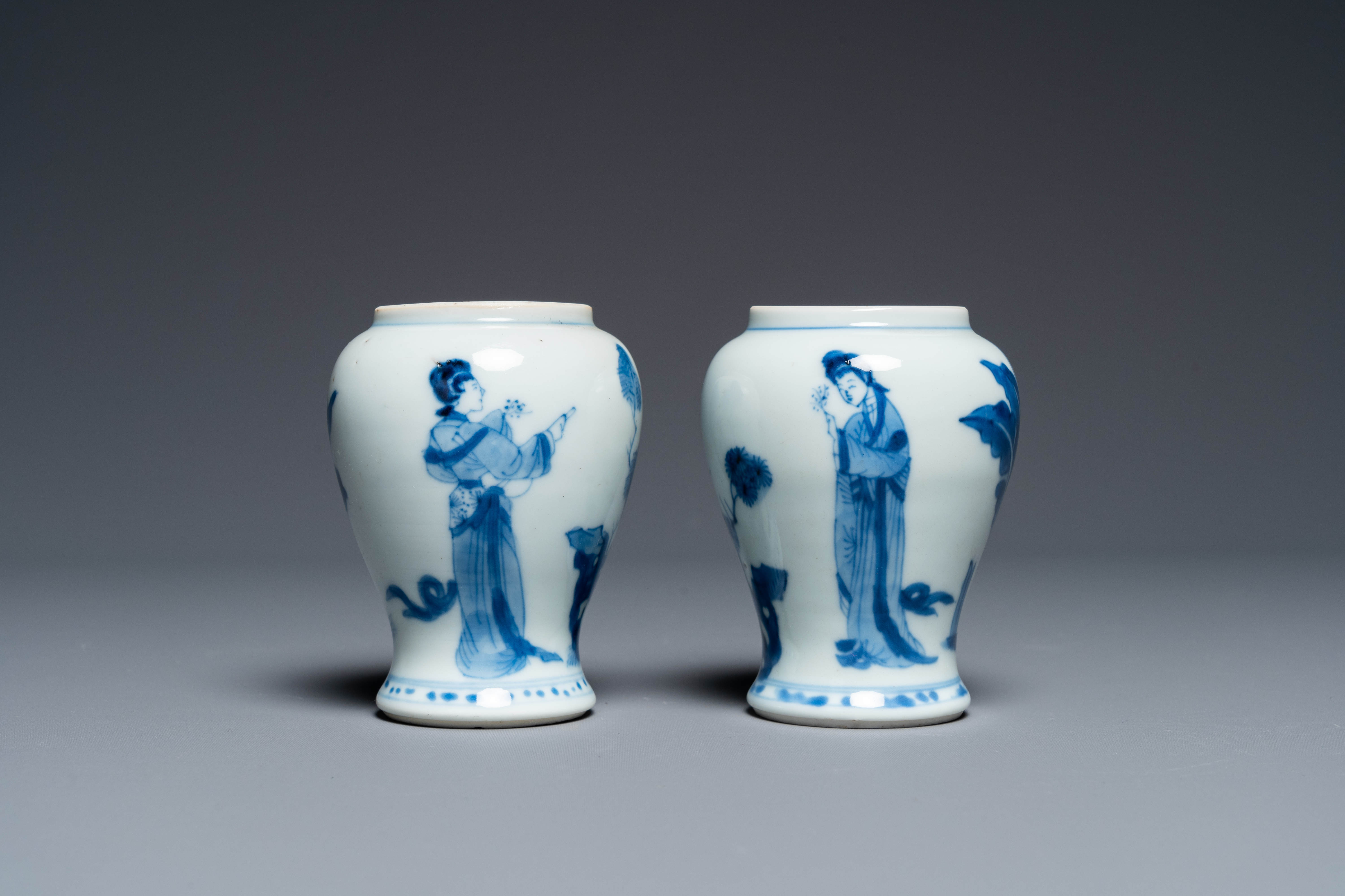 A pair of Chinese blue and white small vases with ladies, Kangxi