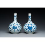 A pair of Chinese blue and white 'peony scroll' pharmacy bottles, Kangxi