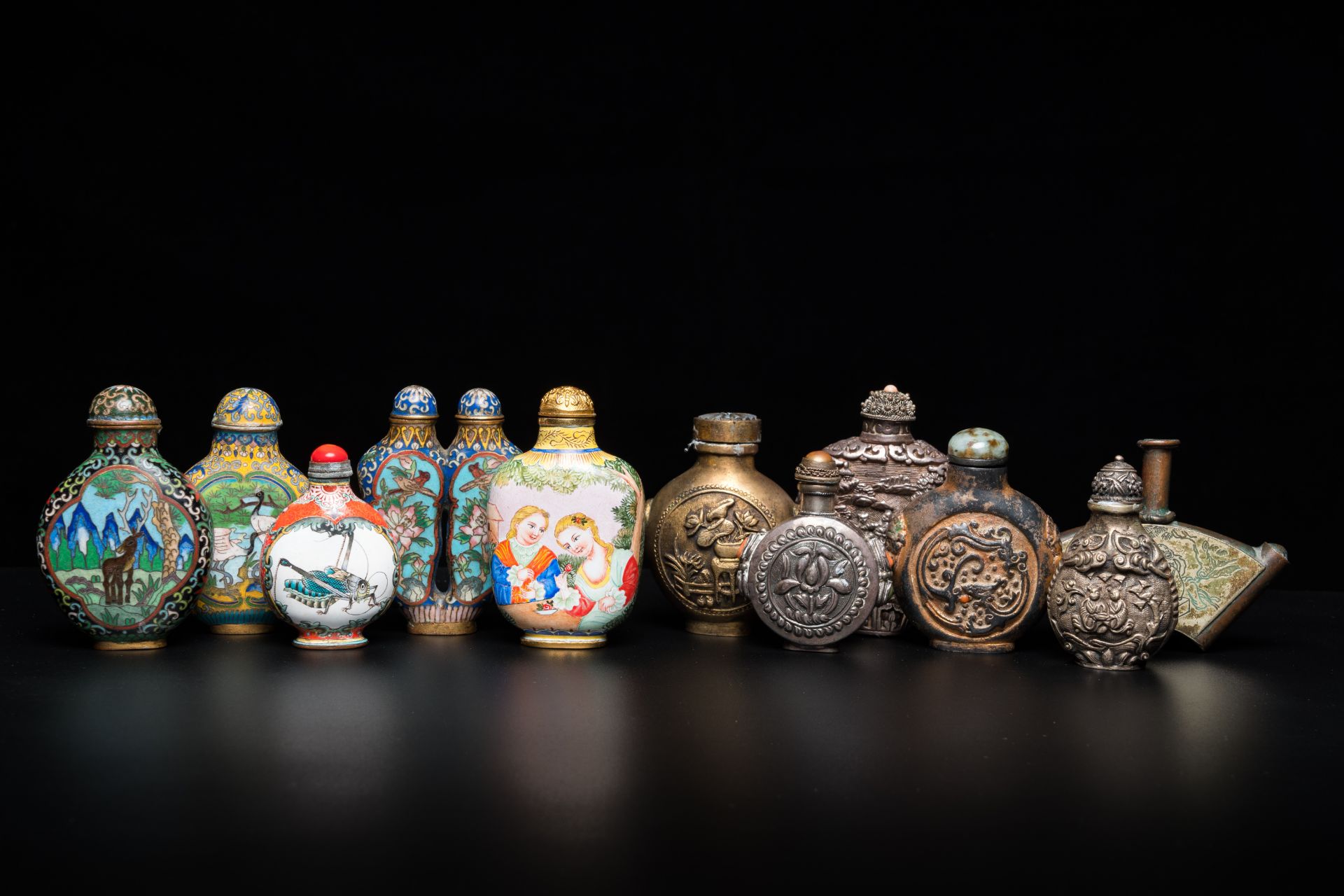 Eleven Chinese Canton enamel, cloisonnŽ, silver and other metal snuff bottles, 19/20th C.